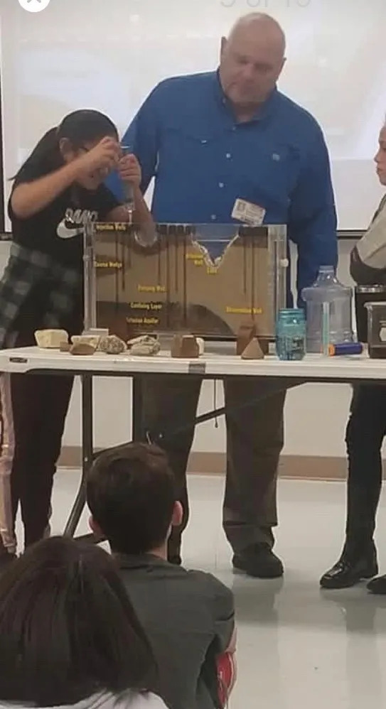 Child demonstrating something in front of class