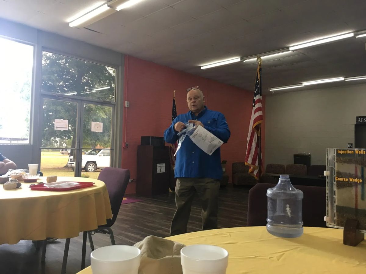 man in blue shirt talking 