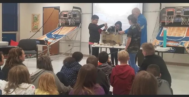 Child demonstrating something in front of class